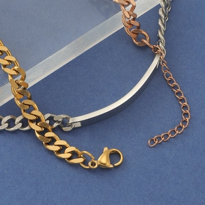 Macro shot of gold, silver and rose gold stainless steel cuban chain bracelets with custom plate