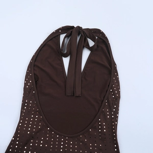 Detailed view of bronze sequin halter jumpsuit with open back and sparkling dots