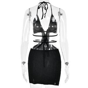 Back view of a black knitted halter top and mini skirt set showing cutout back details