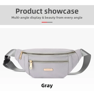Detailed view of grey nylon waist bag featuring dual gold zippers and adjustable black strap