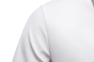 Close-up of white pique fabric texture and durable shoulder stitching on a polo shirt