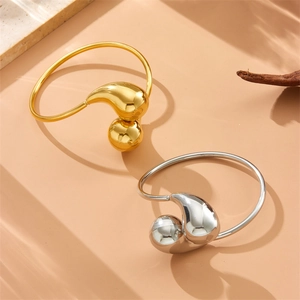 Minimalist stainless steel teardrop cuff bracelets in polished gold and silver finishes