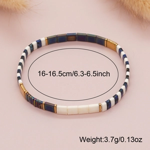 Handmade Tila bead stretch bracelet with blue and white tiles and gold accents
