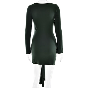 Detail view showing the back of a slim fit dark green long sleeve dress with premium texture