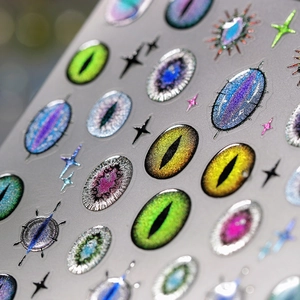 Macro shot of 3D devil eye nail stickers with holographic laser finish and star patterns