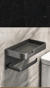 Detail of matte black wall-mounted bathroom tissue holder with protective side rails