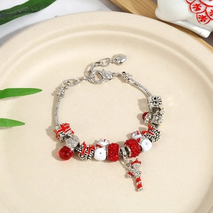 Detailed view of Christmas charm bracelet with silver snake chain and red snowman pendants