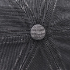 Close-up of washed dark gray baseball cap showing top button and six-panel stitching details