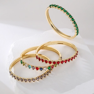 Luxurious 18K gold plated heart zircon bangle featuring vibrant emerald and ruby gemstones