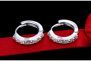 Detailed close-up of S925 sterling silver hoop earrings with clear zirconia stones