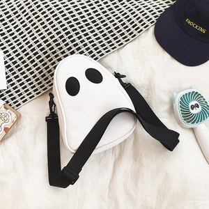 Detailed top view of white ghost crossbody bag with black woven strap and eyes