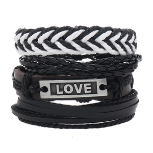 Detail view of 4-piece leather bracelet set with woven straps and LOVE metal plate