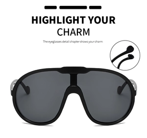 Detail view showing black oversized shield sunglasses with silver metal temples and ear tips