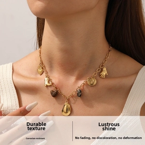 Detail of vintage gold-plated necklace with western cowboy boot and hat charms