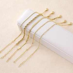 5-piece gold-plated chain bracelet set with snake, twist, and figaro styles on display