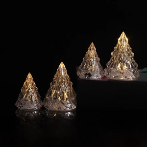 Macro detail of four LED crystal iceberg lamps with warm light on reflective surface