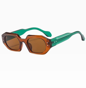 Detailed view of polygon sunglasses with transparent tea frame and green temples