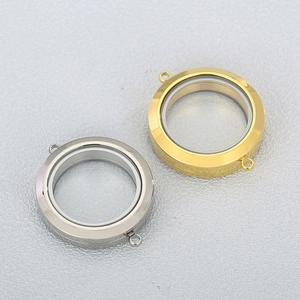 Macro view of gold and silver openable round locket pendants with dual hanging loops