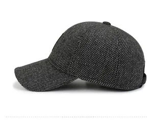 Detailed side view of dark grey wool blend baseball cap with thick warm ear flaps