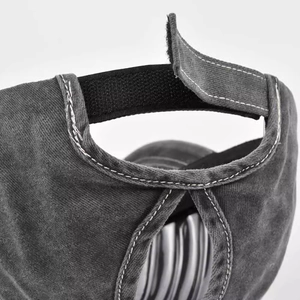 Macro detail of adjustable velcro strap and ponytail opening on washed cotton baseball cap