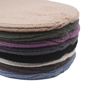 Macro detail of thick knit textures and diverse color palette for winter beanies