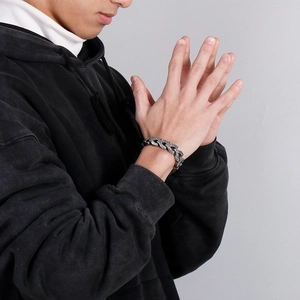 Close-up of men's retro dragon bone chain bracelet in antique silver titanium steel finish