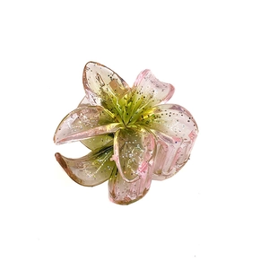 Macro detail of 4cm translucent glitter flower hair claw with pink and green gradient