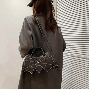 Detailed view of black bat-shaped PU leather crossbody bag with spider web embroidery