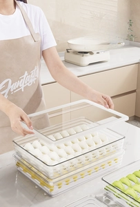 Close-up of clear food-grade dumpling storage box with lid and stackable layers in kitchen