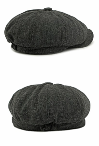 Detail view of dark grey herringbone newsboy cap with classic wool blend tweed texture