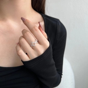 Elegant S925 sterling silver ring featuring hollow clover patterns and sparkling zircon stones