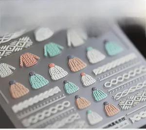 Detailed 5D textured nail art stickers with embossed winter sweater knit patterns