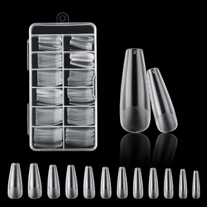 Macro shot of 12 transparent frosted coffin fake nails with sizes 0-11 on black background