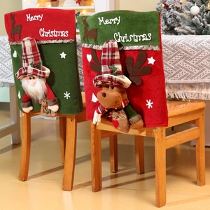Detail of Christmas chair covers featuring 3D Santa and reindeer plush characters
