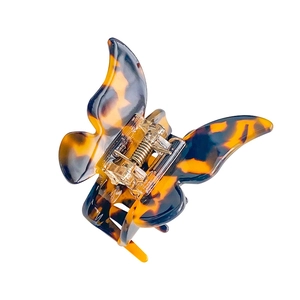 Elegant butterfly hair claw clip with amber tortoise shell pattern in acetate resin
