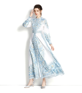 Detail of elegant paisley print maxi dress featuring stand collar and matching waist belt