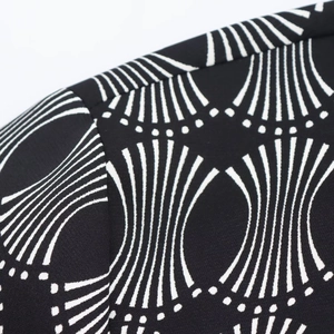 Detailed close-up of geometric wave pattern on a women's blouse shoulder and collar