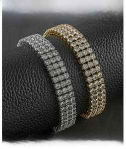 Detailed macro view of gold and silver hip hop bracelets with four rows of crystal stones