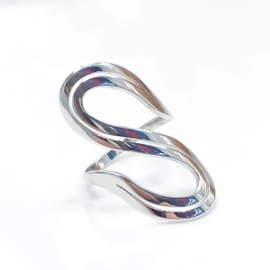 Polished silver infinity S-shape titanium steel ring detail on white background
