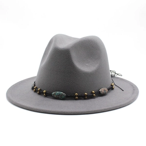 Close-up of grey wool fedora hat with turquoise bead and black woven band detail