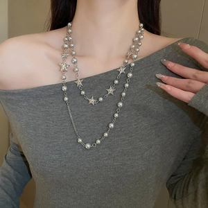 Star and pearl beaded double layer necklace on model featuring elegant silver star pendants