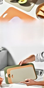Three-piece non-slip plastic cutting board set in green, orange, and beige with hanging holes