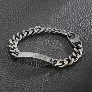 Close-up of silver Cuban chain bracelet with rectangular ID tag and lobster clasp