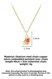 Macro view of gold crab pendant with crystals and gradient stone on titanium chain
