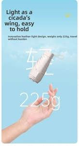 Ultralight beige 6-fold umbrella weighing 225g floating over a palm for weightless feel