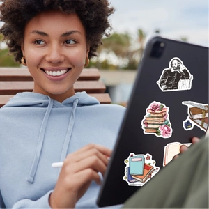 Detail of literary stickers with books and Shakespeare on a tablet case