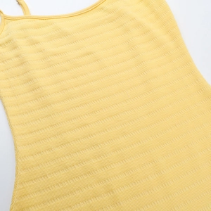 Close-up of light yellow knit fabric showing detailed ribbed texture and soft material