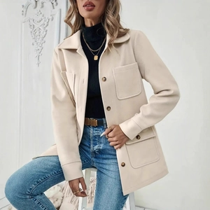 Detail of cream oversized wool blend jacket featuring utility pockets and dark buttons