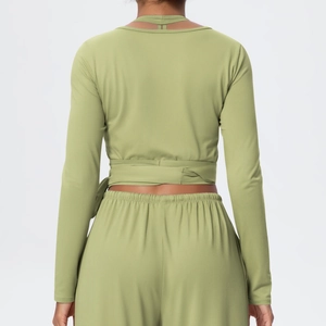 Detail of cross-tie back design on this slim fit green long-sleeved yoga set