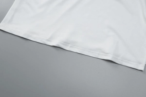 Close-up of the fine stitching and white fabric hemline on the sleeveless split dress